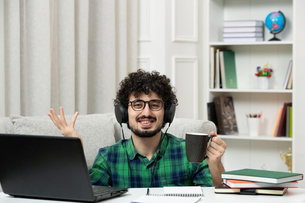 student-online-cute-young-guy-studying-computer-glasses-green-shirt-with-cup-happy_140725-164742