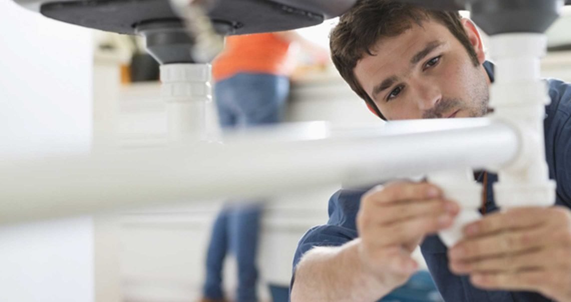 A digital marketing plumber working on a wash basin.