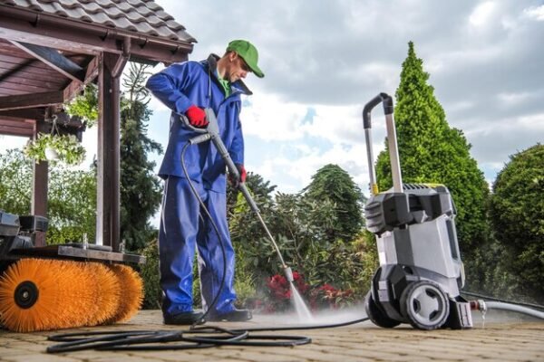 Professional cleaning equipment, including an electric pressure washer, being used to clean a commercial space efficiently